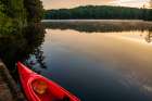 USA, New York. Adirondack Park, Saranac Lake, Hoel Pond, canoe at boathouse dock. Art Print